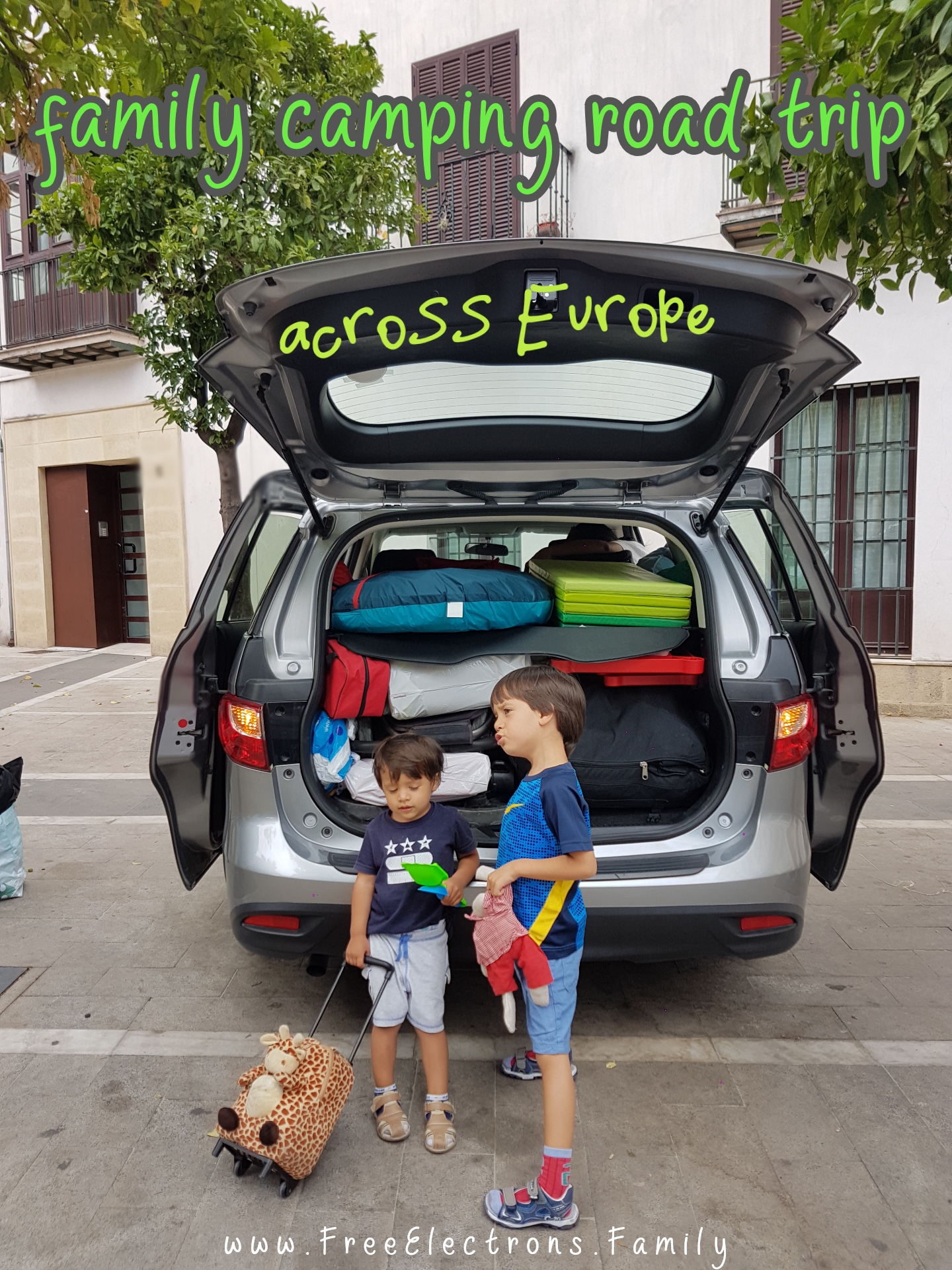 #FreeElectrons.Family - camping road trip Europe, Spain.

2 young kids in t-shirts and shorts await to get on a fully packed Mazda 5 to start their family fun summer camping road trip across Europe.